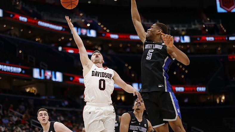 Mar 12, 2022; Washington, D.C., USA; Davidson Wildcats guard Foster Loyer (0) shoots the ball as Saint Louis Billikens forward Francis Okoro (5) defends in the first half at Capital One Arena. Mandatory Credit: Geoff Burke-USA TODAY Sports