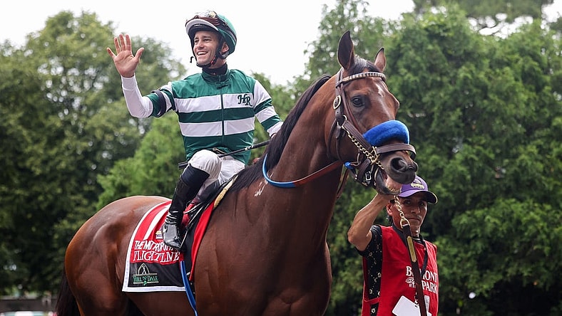 Jun 11, 2022; Elmont, NY, USA; Flightline   s jockey Flavien Prat waves to the crowd as they leave the Paddock before The Hill    N    Dale Metropolitan race at Belmont Park Racetrack. Mandatory Credit: Jessica Alcheh-USA TODAY Sports