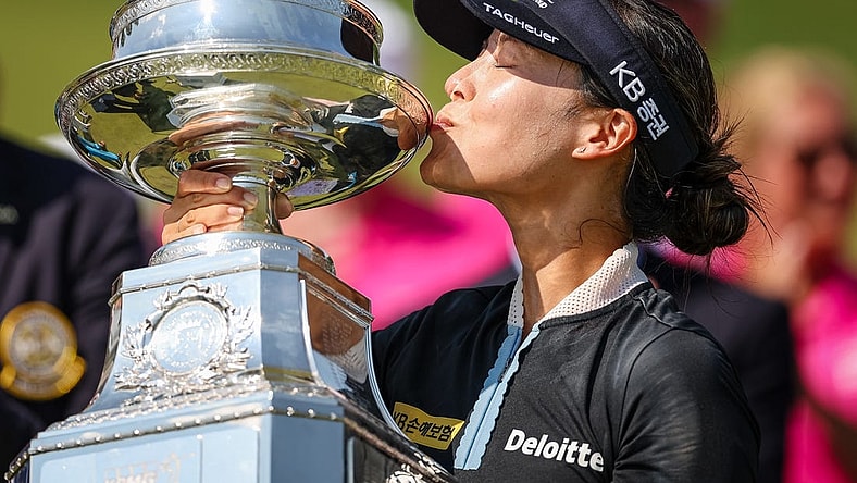 Jun 26, 2022; Bethesda, Maryland, USA; In Gee Chun kisses the trophy after wining the KPMG Women's PGA Championship golf tournament at Congressional Country Club. Mandatory Credit: Scott Taetsch-USA TODAY Sports