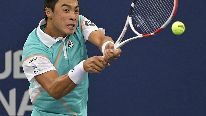 Aug 9, 2022; Montreal, QC, Canada; Brandon Nakashima (USA) hits a backhand against Cameron Norrie (GBR) (not pictured) in first round play in the National Bank Open at IGA Stadium. Mandatory Credit: Eric Bolte-USA TODAY Sports