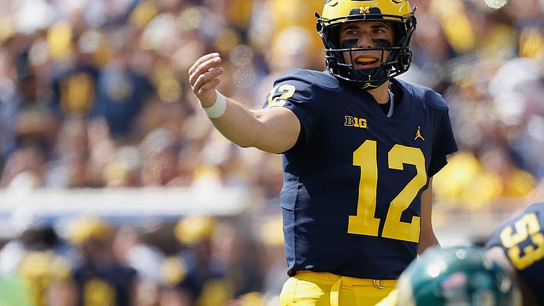Sep 3, 2022; Ann Arbor, Michigan, USA;  Michigan Wolverines quarterback Cade McNamara (12) gets set to run a play against the Colorado State Rams at Michigan Stadium. Mandatory Credit: Rick Osentoski-USA TODAY Sports