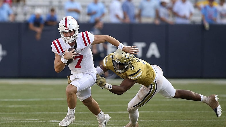 Sep 17, 2022; Atlanta, Georgia, USA; Mississippi Rebels quarterback Luke Altmyer (7) runs past Georgia Tech Yellow Jackets defensive lineman Kyle Kennard (9) in the second half at Bobby Dodd Stadium. Mandatory Credit: Brett Davis-USA TODAY Sports