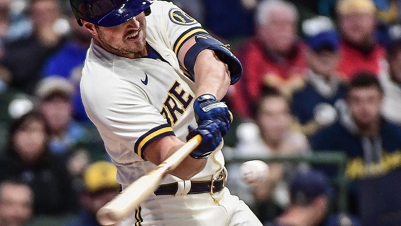 Sep 28, 2022; Milwaukee, Wisconsin, USA; Milwaukee Brewers right fielder Hunter Renfroe (12) hits an RBI single in the third inning against the St. Louis Cardinals at American Family Field. Mandatory Credit: Benny Sieu-USA TODAY Sports
