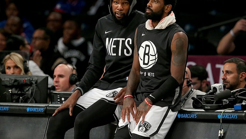 Oct 3, 2022; Brooklyn, New York, USA; Brooklyn Nets forward Kevin Durant (7) and guard Kyrie Irving (11) wait to check into the game against the Philadelphia 76ers during the second quarter at Barclays Center. Mandatory Credit: Brad Penner-USA TODAY Sports