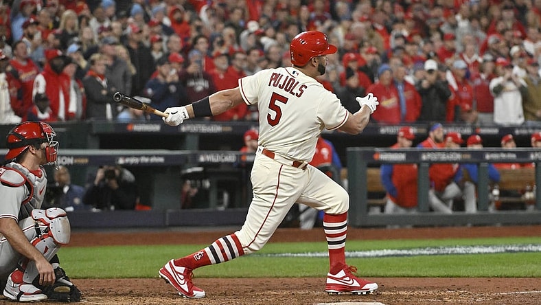 Oct 8, 2022; St. Louis, Missouri, USA; St. Louis Cardinals designated hitter Albert Pujols (5) hits a single in the eighth inning against the Philadelphia Phillies during game two of the Wild Card series for the 2022 MLB Playoffs at Busch Stadium. Mandatory Credit: Jeff Curry-USA TODAY Sports