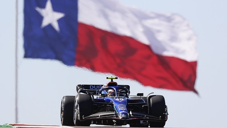 Oct 21, 2022; Austin, Texas, USA;  Williams Mercedes driver Logan Sargeant (45) passes the Texas flag during practice for the U.S. Grand Prix at Circuit of the Americas. Mandatory Credit: Erich Schlegel-USA TODAY Sports