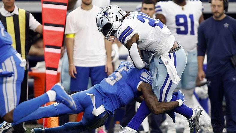 Oct 23, 2022; Arlington, Texas, USA; Dallas Cowboys running back Ezekiel Elliott (21) is tackled by Detroit Lions safety DeShon Elliott (5) in the second quarter at AT&T Stadium. Mandatory Credit: Tim Heitman-USA TODAY Sports