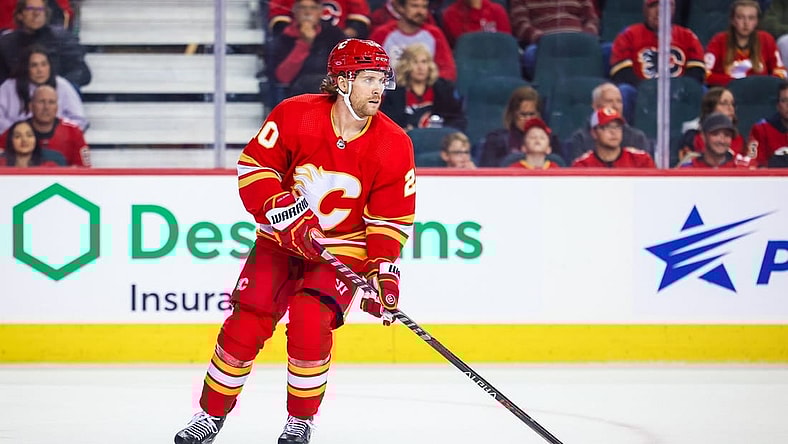 Oct 22, 2022; Calgary, Alberta, CAN; Calgary Flames center Blake Coleman (20) controls the puck against the Carolina Hurricanes during the first period at Scotiabank Saddledome. Mandatory Credit: Sergei Belski-USA TODAY Sports