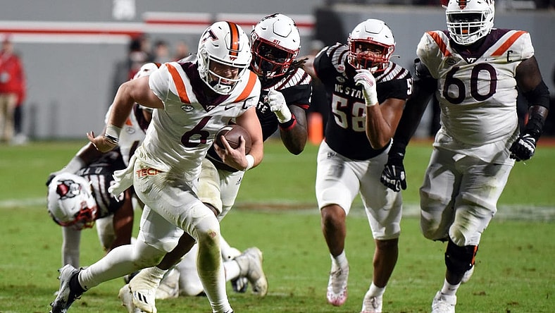 Oct 27, 2022; Raleigh, North Carolina, USA; Virginia Tech Hokies quarterback Grant Wells (6) runs for a touchdown during the second half against the North Carolina State Wolfpack at Carter-Finley Stadium.  The Wolfpack won 22-21. Mandatory Credit: Rob Kinnan-USA TODAY Sports