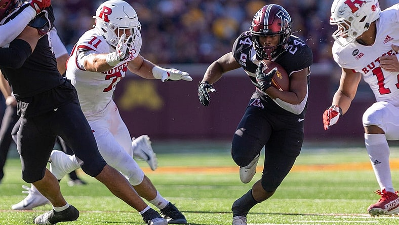 Oct 29, 2022; Minneapolis, Minnesota, USA; Minnesota Golden Gophers running back Mohamed Ibrahim (24) evades Rutgers Scarlet Knights defensive lineman Aaron Lewis (71) in the first quarter at Huntington Bank Stadium. Mandatory Credit: Matt Blewett-USA TODAY Sports