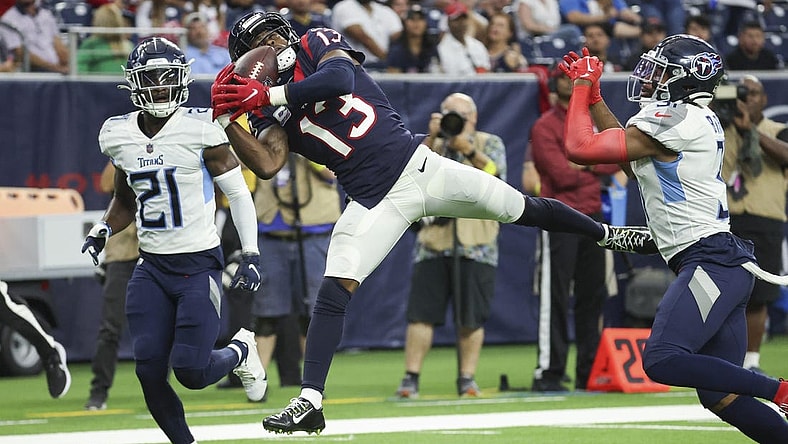 Oct 30, 2022; Houston, Texas, USA; Houston Texans wide receiver Brandin Cooks (13) makes a reception during the fourth quarter as Tennessee Titans cornerback Roger McCreary (21) defends at NRG Stadium. Mandatory Credit: Troy Taormina-USA TODAY Sports