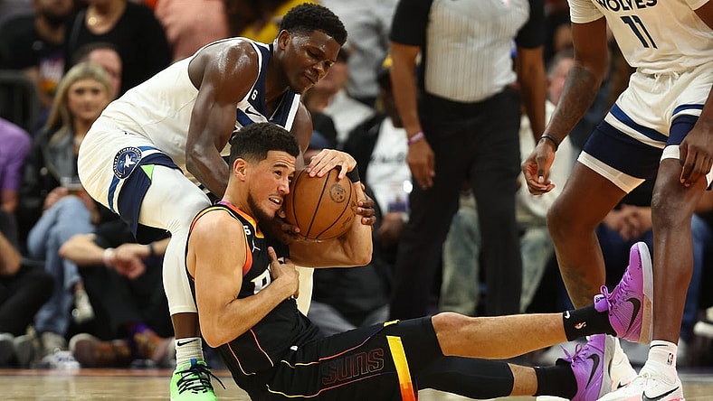 Nov 1, 2022; Phoenix, Arizona, USA; Phoenix Suns guard Devin Booker (bottom) battles for a loose ball with Minnesota Timberwolves guard Anthony Edwards in the first half at Footprint Center. Mandatory Credit: Mark J. Rebilas-USA TODAY Sports