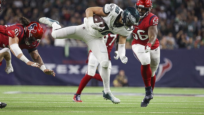 Nov 3, 2022; Houston, Texas, USA; Philadelphia Eagles tight end Dallas Goedert (88) leaps with the ball as Houston Texans defensive tackle Thomas Booker IV (56) defends during the second quarter at NRG Stadium. Mandatory Credit: Troy Taormina-USA TODAY Sports