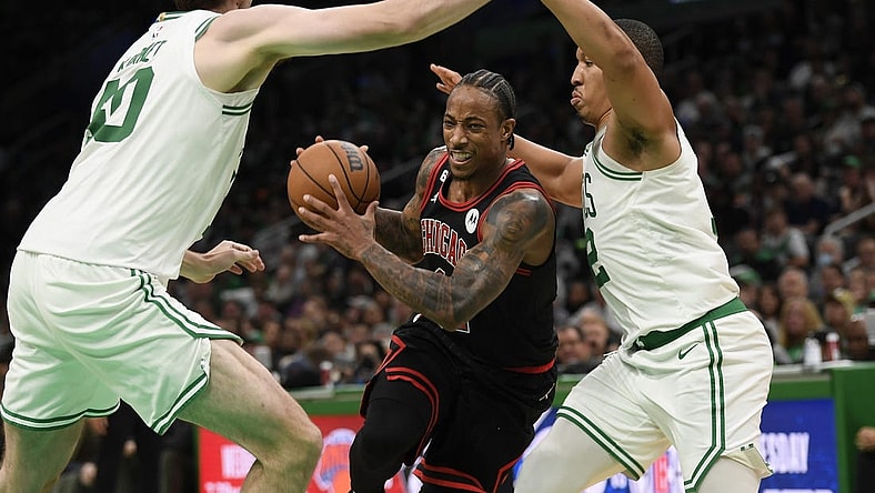 Nov 4, 2022; Boston, Massachusetts, USA;  Chicago Bulls forward DeMar DeRozan (11) controls the ball while Boston Celtics center Luke Kornet (40) and forward Grant Williams (12) defend during the second half at TD Garden. Mandatory Credit: Bob DeChiara-USA TODAY Sports