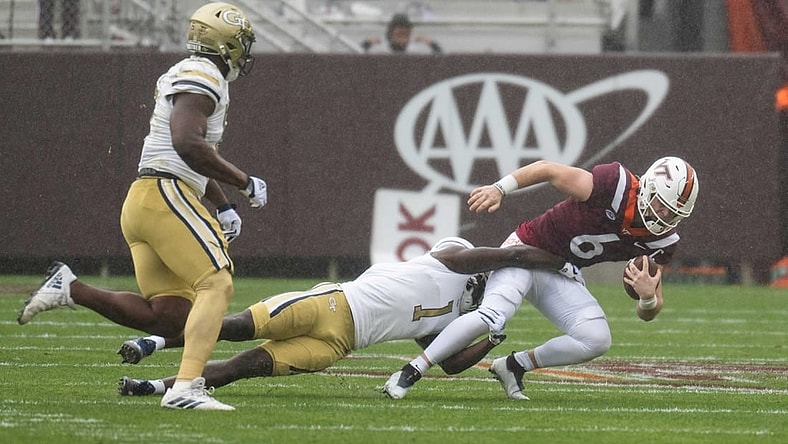 Nov 5, 2022; Blacksburg, Virginia, USA; Virginia Tech Hokies quarterback Grant Wells (6) gets tackled by Georgia Tech Yellow Jackets linebacker Charlie Thomas (1 at )Lane Stadium in the first half. Mandatory Credit: Lee Luther Jr.-USA TODAY Sports