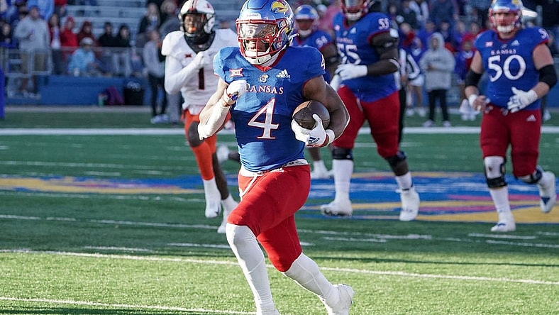 Nov 5, 2022; Lawrence, Kansas, USA; Kansas Jayhawks running back Devin Neal (4) runs the ball against the Oklahoma State Cowboys during the second half of the game at David Booth Kansas Memorial Stadium. Mandatory Credit: Denny Medley-USA TODAY Sports