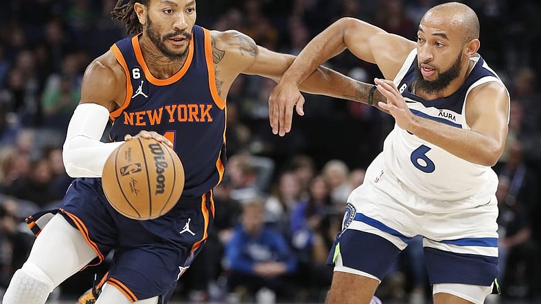 Nov 7, 2022; Minneapolis, Minnesota, USA; New York Knicks guard Derrick Rose (4) drives to the basket around Minnesota Timberwolves guard Jordan McLaughlin (6) in the first quarter at Target Center. Mandatory Credit: Bruce Kluckhohn-USA TODAY Sports