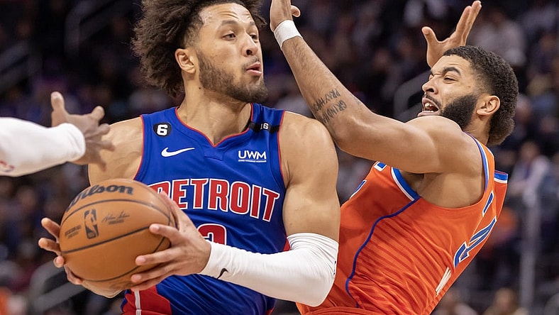 Nov 7, 2022; Detroit, Michigan, USA; Detroit Pistons guard Cade Cunningham (2) drives to the basket on Oklahoma City Thunder forward Kenrich Williams (34) during the in the second half at Little Caesars Arena. Mandatory Credit: David Reginek-USA TODAY Sports