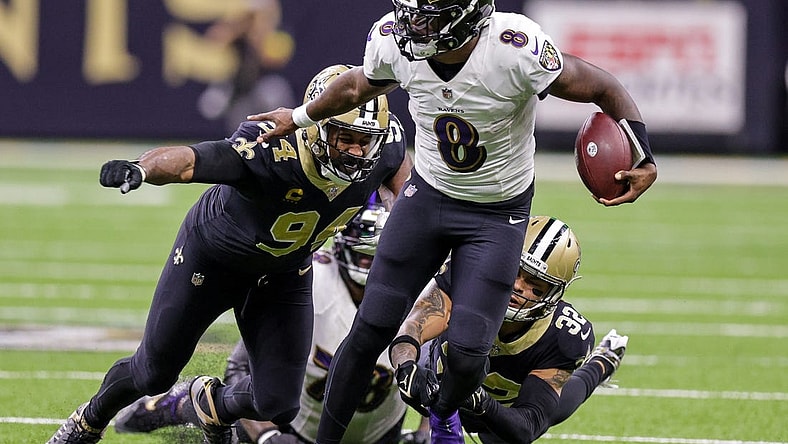 fNov 7, 2022; New Orleans, Louisiana, USA;  Baltimore Ravens quarterback Lamar Jackson (8) scrambles away from New Orleans Saints defensive end Cameron Jordan (94) and safety Tyrann Mathieu (32) during the second half at Caesars Superdome. Mandatory Credit: Stephen Lew-USA TODAY Sports