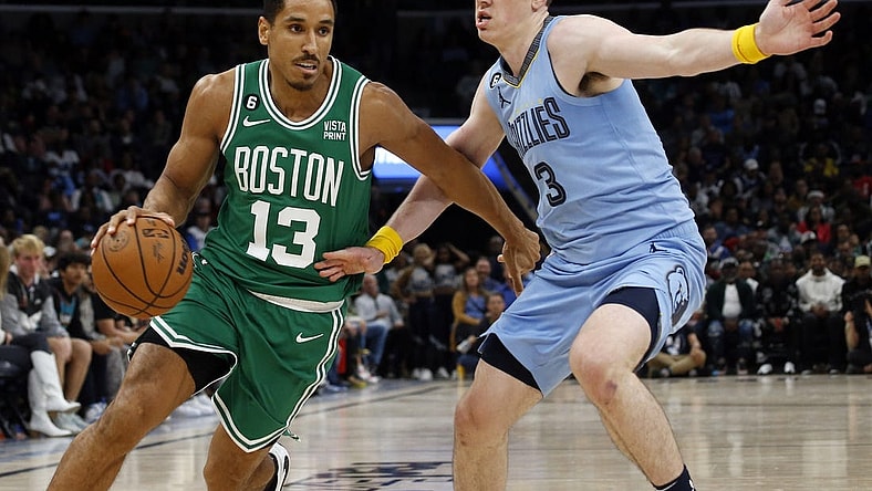 Nov 7, 2022; Memphis, Tennessee, USA; Boston Celtics guard Malcolm Brogdon (13) dribbles as Memphis Grizzlies forward Jake LaRavia (3) defends during the second half at FedExForum. Mandatory Credit: Petre Thomas-USA TODAY Sports