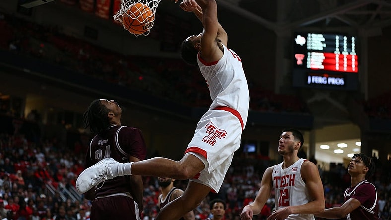 Nov 10, 2022; Lubbock, Texas, USA; Texas Tech Red Raiders forward Kevin Obanor (0) does a reverse dunk against Texas Southern Tigers forward John Walker III (24) in the second half at United Supermarkets Arena. Mandatory Credit: Michael C. Johnson-USA TODAY Sports