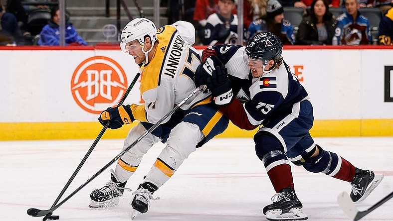 Nov 10, 2022; Denver, Colorado, USA; Nashville Predators center Mark Jankowski (17) controls the puck under pressure from h75 in the third period at Ball Arena. Mandatory Credit: Isaiah J. Downing-USA TODAY Sports