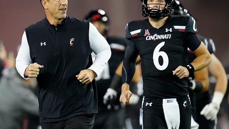Cincinnati Bearcats head coach Luke Fickell and quarterback Ben Bryant (6) take the field for the first quarter of the NCAA American Athletic Conference game between the Cincinnati Bearcats and the East Carolina Pirates at Nippert Stadium in Cincinnati on Friday, Nov. 11, 2022.

East Carolina Pirates At Cincinnati Bearcats Football