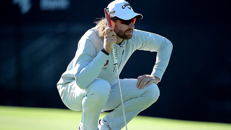 Nov 12, 2022; Houston, Texas, USA; Patrick Rodgers kneels on the green while waiting to putt on the ninth hole during the third round of the Cadence Bank Houston Open golf tournament. Mandatory Credit: Erik Williams-USA TODAY Sports