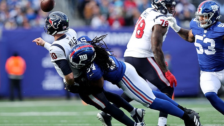 Nov 13, 2022; East Rutherford, New Jersey, USA; Houston Texans quarterback Davis Mills (10) throws an incomplete pass under pressure from New York Giants linebacker Jaylon Smith (54) during the second quarter at MetLife Stadium. Mandatory Credit: Brad Penner-USA TODAY Sports