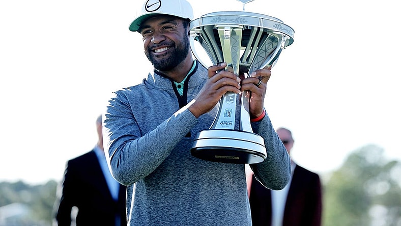Nov 13, 2022; Houston, Texas, USA; Tony Finau raises the championship trophy after winning the Cadence Bank Houston Open golf tournament. Mandatory Credit: Erik Williams-USA TODAY Sports