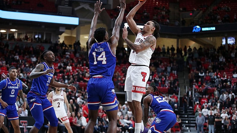 Nov 14, 2022; Lubbock, Texas, USA; Texas Tech Red Raiders guard Jaylon Tyson (20) shoots over Louisiana Tech Bulldogs forward Will Allen (14) in the first half at United Supermarkets Arena. Mandatory Credit: Michael C. Johnson-USA TODAY Sports