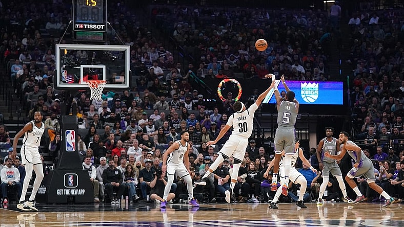 Nov 15, 2022; Sacramento, California, USA; Sacramento Kings guard De'Aaron Fox (5) makes a shot over Brooklyn Nets guard Seth Curry (30) at the end of the first quarter at the Golden 1 Center. Mandatory Credit: Cary Edmondson-USA TODAY Sports