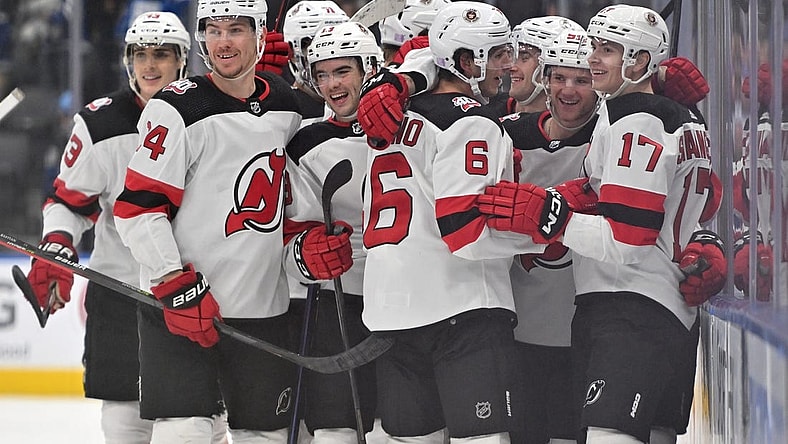 Nov 17, 2022; Toronto, Ontario, CAN; New Jersey Devils forward Yegor Sharangovich (17) celebrates with teammates after scoring a goal in overtime against the Toronto Maple Leafs at Scotiabank Arena. Mandatory Credit: Dan Hamilton-USA TODAY Sports