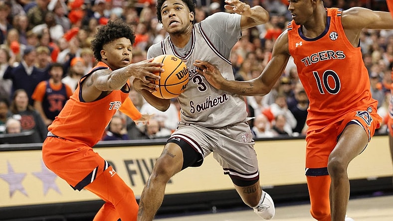 Nov 18, 2022; Auburn, Alabama, USA;  Auburn Tigers guards Wendell Green Jr. (1) and Chance Westry (10) strip the ball from Texas Southern Tigers guard PJ Henry (3) during the first half at Neville Arena. Mandatory Credit: John Reed-USA TODAY Sports