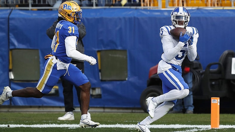 Nov 19, 2022; Pittsburgh, Pennsylvania, USA; Duke Blue Devils wide receiver Jalon Calhoun (5) catches a touchdown pass behind Pittsburgh Panthers defensive back Erick Hallett II (31) during the first quarter at Acrisure Stadium. Mandatory Credit: Charles LeClaire-USA TODAY Sports