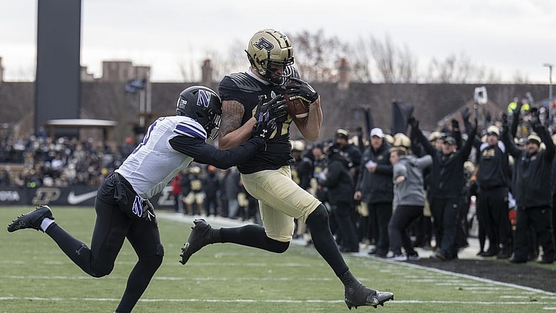 Nov 19, 2022; West Lafayette, Indiana, USA; Purdue Boilermakers tight end Payne Durham (87) catches a pass that results in a touchdown against Northwestern Wildcats defensive back Jeremiah Lewis (9) during the second quarter at Ross-Ade Stadium. Mandatory Credit: Marc Lebryk-USA TODAY Sports
