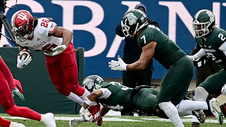 Nov 19, 2022; East Lansing, Michigan, USA;  Michigan State Spartans safety Khalil Majeed (34) tackles Indiana Hoosiers running back Josh Henderson (26) in the second quarter at Spartan Stadium. Mandatory Credit: Dale Young-USA TODAY Sports