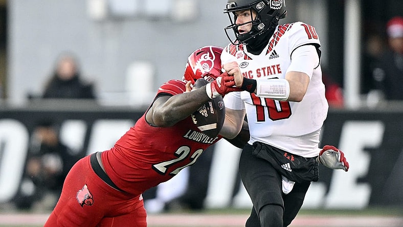 Nov 19, 2022; Louisville, Kentucky, USA;  Louisville Cardinals linebacker Yasir Abdullah (22) sacks North Carolina State Wolfpack quarterback Ben Finley (10) during the second quarter at Cardinal Stadium. Mandatory Credit: Jamie Rhodes-USA TODAY Sports