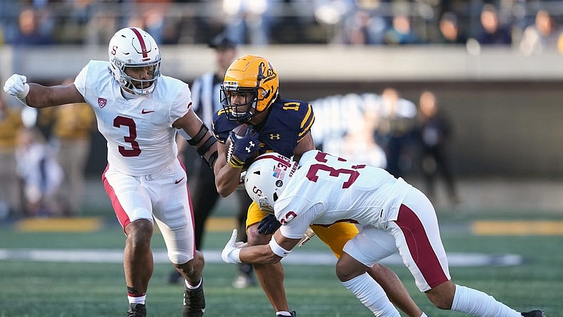 Nov 19, 2022; Berkeley, California, USA; California Golden Bears wide receiver Mavin Anderson (11) runs after a catch against Stanford Cardinal linebacker Levani Damuni (3) and safety Alaka'i Gilman (33) during the second quarter at FTX Field at California Memorial Stadium. Mandatory Credit: Darren Yamashita-USA TODAY Sports
