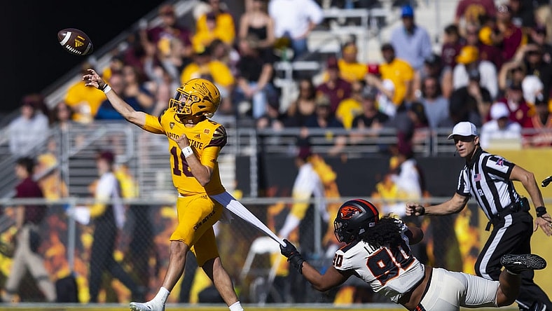 Nov 19, 2022; Tempe, Arizona, USA; Arizona State Sun Devils quarterback Trenton Bourguet (16) throws a pass under pressure from Oregon State Beavers defensive lineman Sione Lolohea (90) during the first half at Sun Devil Stadium. Mandatory Credit: Mark J. Rebilas-USA TODAY Sports