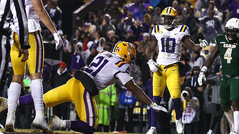Nov 19, 2022; Baton Rouge, Louisiana, USA;  LSU Tigers quarterback Tavion Faulk (12) falls into the end zone for a touchdown against the UAB Blazers during the first half at Tiger Stadium. Mandatory Credit: Stephen Lew-USA TODAY Sports