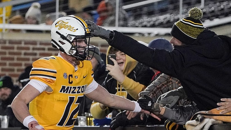 Nov 19, 2022; Columbia, Missouri, USA; Missouri Tigers quarterback Brady Cook (12) celebrates with fans after a score against the New Mexico State Aggies during the second half at Faurot Field at Memorial Stadium. Mandatory Credit: Denny Medley-USA TODAY Sports