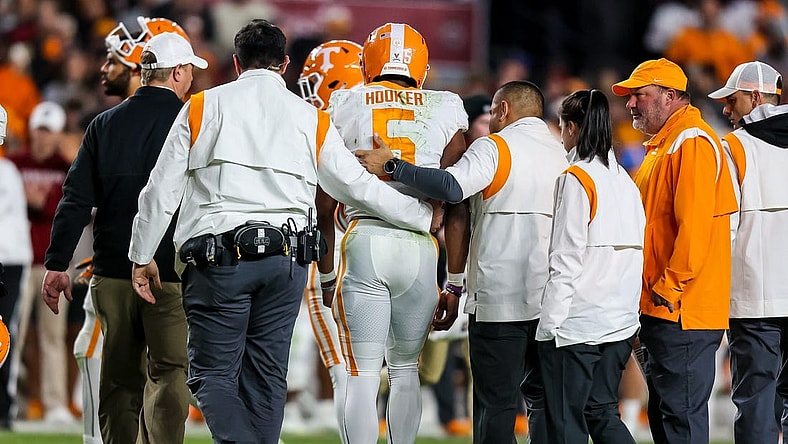 Nov 19, 2022; Columbia, South Carolina, USA; Tennessee Volunteers quarterback Hendon Hooker (5) is assisted off the field after suffering an apparent injury against the South Carolina Gamecocks in the second half at Williams-Brice Stadium. Mandatory Credit: Jeff Blake-USA TODAY Sports