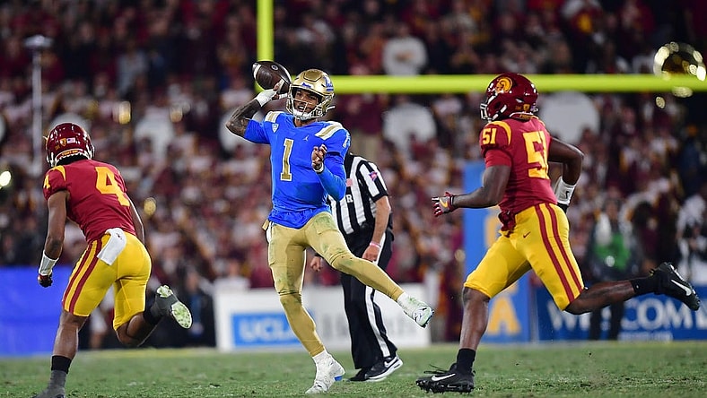 Nov 19, 2022; Pasadena, California, USA; UCLA Bruins quarterback Dorian Thompson-Robinson (1) throws as Southern California Trojans defensive back Max Williams (4) and defensive lineman Solomon Byrd (51) move in during the second half at the Rose Bowl. Mandatory Credit: Gary A. Vasquez-USA TODAY Sports