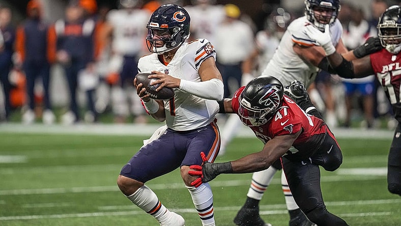 Nov 20, 2022; Atlanta, Georgia, USA; Chicago Bears quarterback Justin Fields (1) tries to evade a tackle by Atlanta Falcons defensive end Arnold Ebiketie (47) during the second half at Mercedes-Benz Stadium. Mandatory Credit: Dale Zanine-USA TODAY Sports