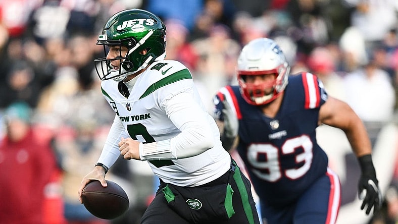 Nov 20, 2022; Foxborough, Massachusetts, USA; New York Jets quarterback Zach Wilson (2) runs under pressure from New England Patriots defensive end Lawrence Guy (93) during the first half at Gillette Stadium. Mandatory Credit: Brian Fluharty-USA TODAY Sports