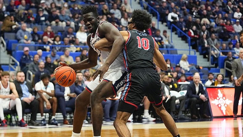 Nov 20, 2022; Hartford, Connecticut, USA; Connecticut Huskies forward Adama Sanogo (21) dribbles the ball against Delaware State Hornets forward Ronald Lucas (10) during the second half at XL Center. Mandatory Credit: Gregory Fisher-USA TODAY Sports