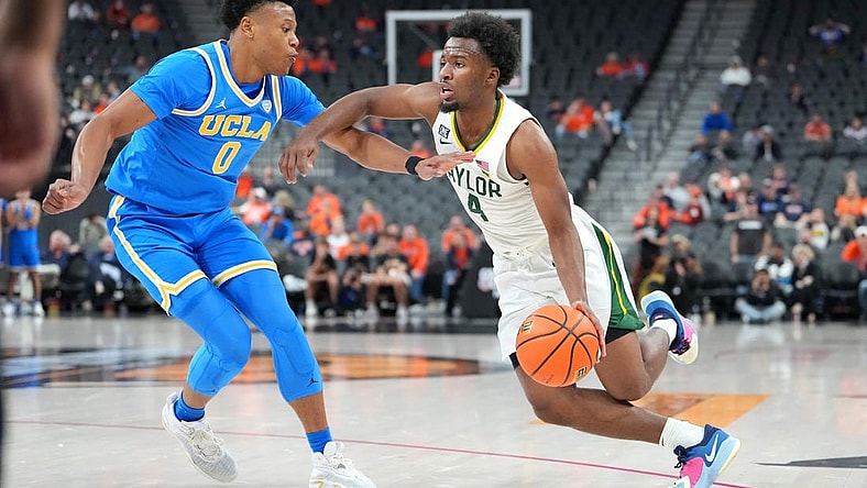 Nov 20, 2022; Las Vegas, Nevada, USA; Baylor Bears guard LJ Cryer (4) dribbles against UCLA Bruins guard Jaylen Clark (0) during the second half at T-Mobile Arena. Mandatory Credit: Stephen R. Sylvanie-USA TODAY Sports