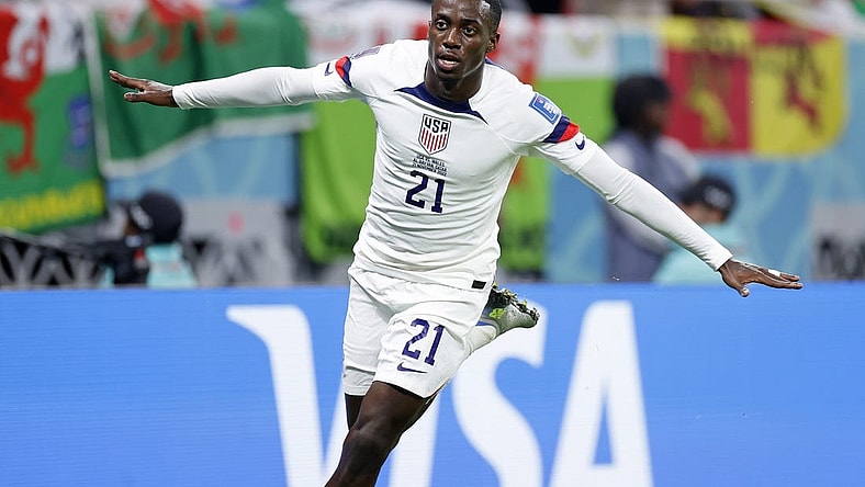 Nov 21, 2022; Al Rayyan, Qatar; United States of America forward Timothy Weah (21) reacts after scoring a goal against Wales during the first half during a group stage match during the 2022 FIFA World Cup at Ahmed Bin Ali Stadium. Mandatory Credit: Yukihito Taguchi-USA TODAY Sports