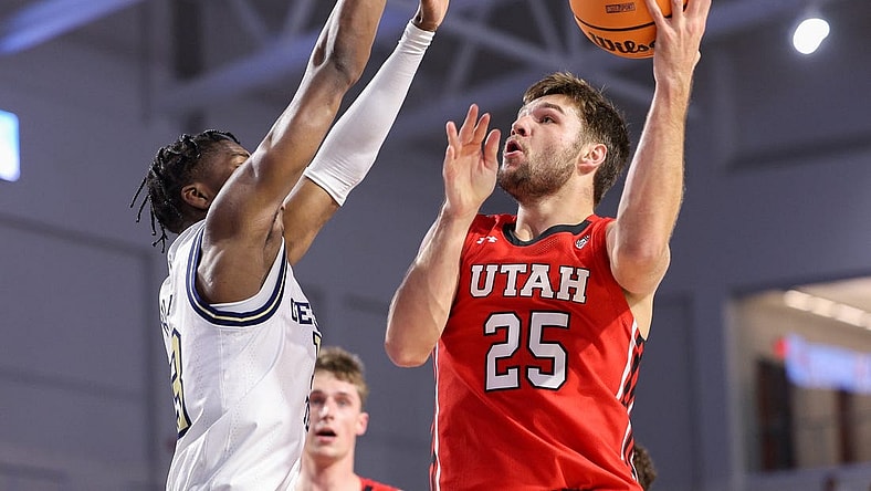 Nov 21, 2022; Fort Myers, Florida, USA;  Utah Utes guard Rollie Worster (25) drives to the basket, defended by Georgia Tech Yellow Jackets guard Miles Kelly (13) in the first half during the Fort Myers Tip-off at Suncoast Credit Union Arena. Mandatory Credit: Nathan Ray Seebeck-USA TODAY Sports